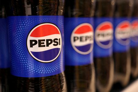Bottles of Pepsi displayed on a supermarket shelf